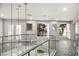 Hallway with glass railing and a view of the backyard and pool area at 2818 E Quail Ave, Las Vegas, NV 89120