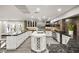 Bright kitchen with stainless steel appliances, black marble countertops, and a central island with a wine rack at 2818 E Quail Ave, Las Vegas, NV 89120