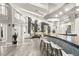 Expansive living area featuring a modern bar, comfortable seating, and elegant lighting fixtures at 2818 E Quail Ave, Las Vegas, NV 89120