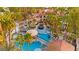 Aerial view of a luxurious backyard featuring a stunning pool with a bridge, water slide, grotto and lush landscaping at 2818 E Quail Ave, Las Vegas, NV 89120