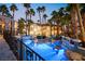 Backyard pool featuring a swim-up bar, grotto, and lush landscaping with tropical foliage at 2818 E Quail Ave, Las Vegas, NV 89120