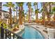 Luxury backyard with a long pool, spa, lush landscaping, and a sun deck with lounge chairs for relaxing at 2818 E Quail Ave, Las Vegas, NV 89120