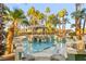 Beautiful backyard pool area featuring a bridge, grotto, spa and cabana, all surrounded by lush landscaping at 2818 E Quail Ave, Las Vegas, NV 89120