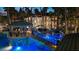 Stunning backyard with a lavish pool area featuring a bridge, grotto, lush landscaping, and gazebo at 2818 E Quail Ave, Las Vegas, NV 89120