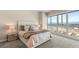 Bright bedroom with a large window offering city and mountain views, plush carpeting and stylish decor at 4525 Dean Martin Dr # 2800, Las Vegas, NV 89103