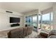 Comfortable living room with large TV, open windows with mountain views, and sliding glass door at 4525 Dean Martin Dr # 2800, Las Vegas, NV 89103