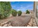 The backyard has gravel landscaping and mature trees, providing a private and relaxing space at 612 Bullwhip Ct, Henderson, NV 89011