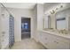 Bathroom features dual sinks, gold fixtures, and modern finishes at 612 Bullwhip Ct, Henderson, NV 89011