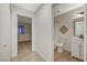 Hallway view to the bathroom with tile floor, bath tub, and mirror at 612 Bullwhip Ct, Henderson, NV 89011