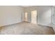 Bedroom featuring neutral carpet with adjoining bathroom and ample natural light at 612 Bullwhip Ct, Henderson, NV 89011
