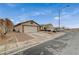 Single-story home featuring a two-car garage, neutral colors, and desert landscaping at 612 Bullwhip Ct, Henderson, NV 89011