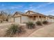 Neutral colored home with desert landscaping, two-car garage and covered porch at 612 Bullwhip Ct, Henderson, NV 89011