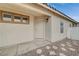 Beige exterior, showing the front door and three windows with brown trim at 612 Bullwhip Ct, Henderson, NV 89011