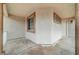 Covered front porch with beige stucco walls and brown trim at 612 Bullwhip Ct, Henderson, NV 89011