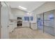 Updated kitchen features white cabinets, stainless appliances, and a skylight, creating a bright and airy space at 612 Bullwhip Ct, Henderson, NV 89011