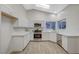Well-lit kitchen with white cabinets, stainless steel appliances, and modern finishes offers ample space and style at 612 Bullwhip Ct, Henderson, NV 89011