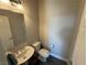 Cozy powder room featuring a pedestal sink, toilet, and clean design at 7068 Parrot Bay Way, Las Vegas, NV 89118