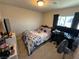 Bedroom features a well-lit workspace, comfortable bed, and ample storage options at 7068 Parrot Bay Way, Las Vegas, NV 89118