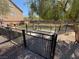 Fenced dog park area with bench and shade trees, perfect for dog owners to enjoy time with their pets at 7068 Parrot Bay Way, Las Vegas, NV 89118