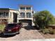 Charming two-story home featuring a paved driveway, a well-maintained lawn, and a two-car garage at 7068 Parrot Bay Way, Las Vegas, NV 89118