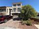 Charming two-story home featuring a paved driveway, a well-maintained lawn, and a two-car garage at 7068 Parrot Bay Way, Las Vegas, NV 89118