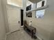 Bright foyer boasts a white front door, tile flooring, and unique shelving and decor at 7068 Parrot Bay Way, Las Vegas, NV 89118