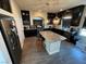 Modern kitchen featuring a large island with granite countertops, and stainless steel appliances at 7068 Parrot Bay Way, Las Vegas, NV 89118