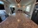 Modern kitchen featuring a large island with granite countertops and stainless steel appliances at 7068 Parrot Bay Way, Las Vegas, NV 89118