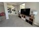 Cozy living room with a large TV, cube storage, and neutral decor at 7068 Parrot Bay Way, Las Vegas, NV 89118