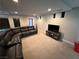 Spacious living room with a comfortable black leather sectional and entertainment center at 7068 Parrot Bay Way, Las Vegas, NV 89118