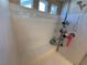 Modern tiled shower with built-in bench, shelving, and shower head at 7068 Parrot Bay Way, Las Vegas, NV 89118