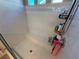 Bright shower featuring tiled walls, a built-in bench, and convenient storage shelves for toiletries at 7068 Parrot Bay Way, Las Vegas, NV 89118