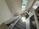 Carpeted staircase with modern railings and sunlit landing showcasing bright, airy design at 7068 Parrot Bay Way, Las Vegas, NV 89118