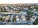 Scenic aerial view of a quiet neighborhood with uniform houses, palm trees, and mountain views at 8072 Big Top Dr, Las Vegas, NV 89123
