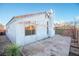 Expansive backyard featuring a concrete patio and a textured white stucco exterior at 8072 Big Top Dr, Las Vegas, NV 89123