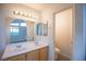 Bathroom featuring a large mirror, double sinks, and plenty of natural light at 8072 Big Top Dr, Las Vegas, NV 89123