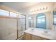 Bright bathroom with double sinks, tub/shower, and sliding glass doors at 8072 Big Top Dr, Las Vegas, NV 89123