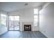 Bright living room features a fireplace, sliding glass doors and gray wood-look floors at 8072 Big Top Dr, Las Vegas, NV 89123