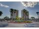 Exterior of building showcasing well-manicured landscaping in a circular driveway and mature palm trees at 8255 S Las Vegas Blvd # 2004, Las Vegas, NV 89123