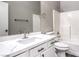 This bathroom features a white vanity, a large mirror, and a shower-tub combo at 904 Melic Way, North Las Vegas, NV 89032