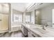 A bathroom with a dual vanity, bathtub and shower at 904 Melic Way, North Las Vegas, NV 89032