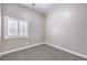 This bedroom features neutral walls, carpet, and a window with shutters at 904 Melic Way, North Las Vegas, NV 89032