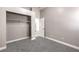 This bedroom features neutral walls, carpet, and an open closet at 904 Melic Way, North Las Vegas, NV 89032