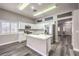 Modern kitchen with white cabinets, stainless steel appliances, an island, and gray wood flooring at 904 Melic Way, North Las Vegas, NV 89032