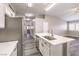 Bright kitchen with white cabinets, an island with sink, stainless steel appliances, and neutral walls at 904 Melic Way, North Las Vegas, NV 89032