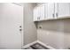 The laundry room features cabinets and a washer and dryer hookup at 904 Melic Way, North Las Vegas, NV 89032