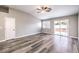Bright living room features wood floors, ceiling fan, and access to the outdoor area at 904 Melic Way, North Las Vegas, NV 89032