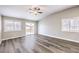 Bright living room features wood floors, ceiling fan, and access to the outdoor area at 904 Melic Way, North Las Vegas, NV 89032