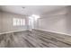Spacious living room showcasing grey wood-style floors, neutral walls and a bright, airy feel at 904 Melic Way, North Las Vegas, NV 89032