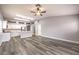 Open-concept living room with wood flooring, bright kitchen, and neutral decor at 904 Melic Way, North Las Vegas, NV 89032
